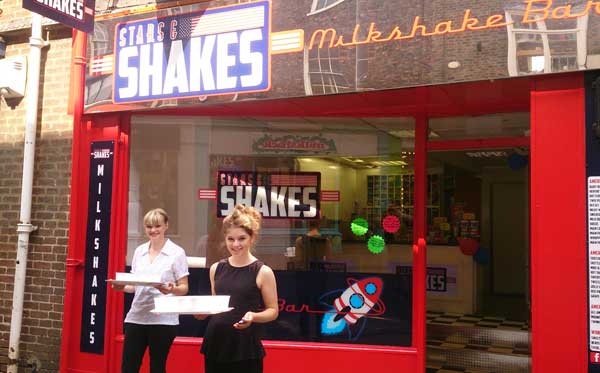 Armed with free shakes, Hannah and Alice outside the Church Street shop